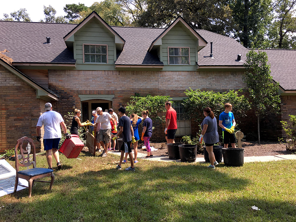 The dark-colored brick on this home shows where water once flowed. Some Halff employees jumped in as "strangers were helping strangers" to get residents back on their feet.