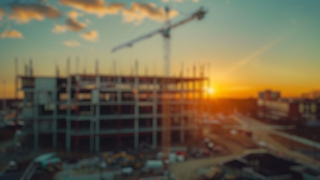 A crane in the background of a building under construction